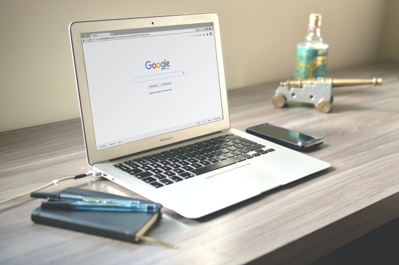 A computer standing on Desk, Displaying Google Main page.