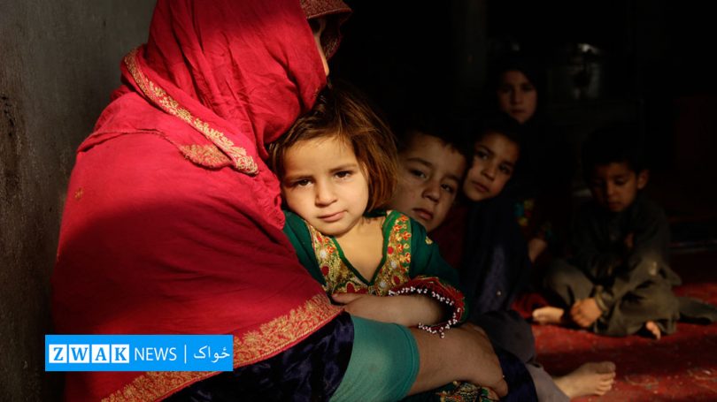 An Afghan mother holds her baby daughter in her arms.